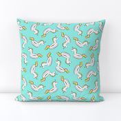 unicorn pool float toss on light teal