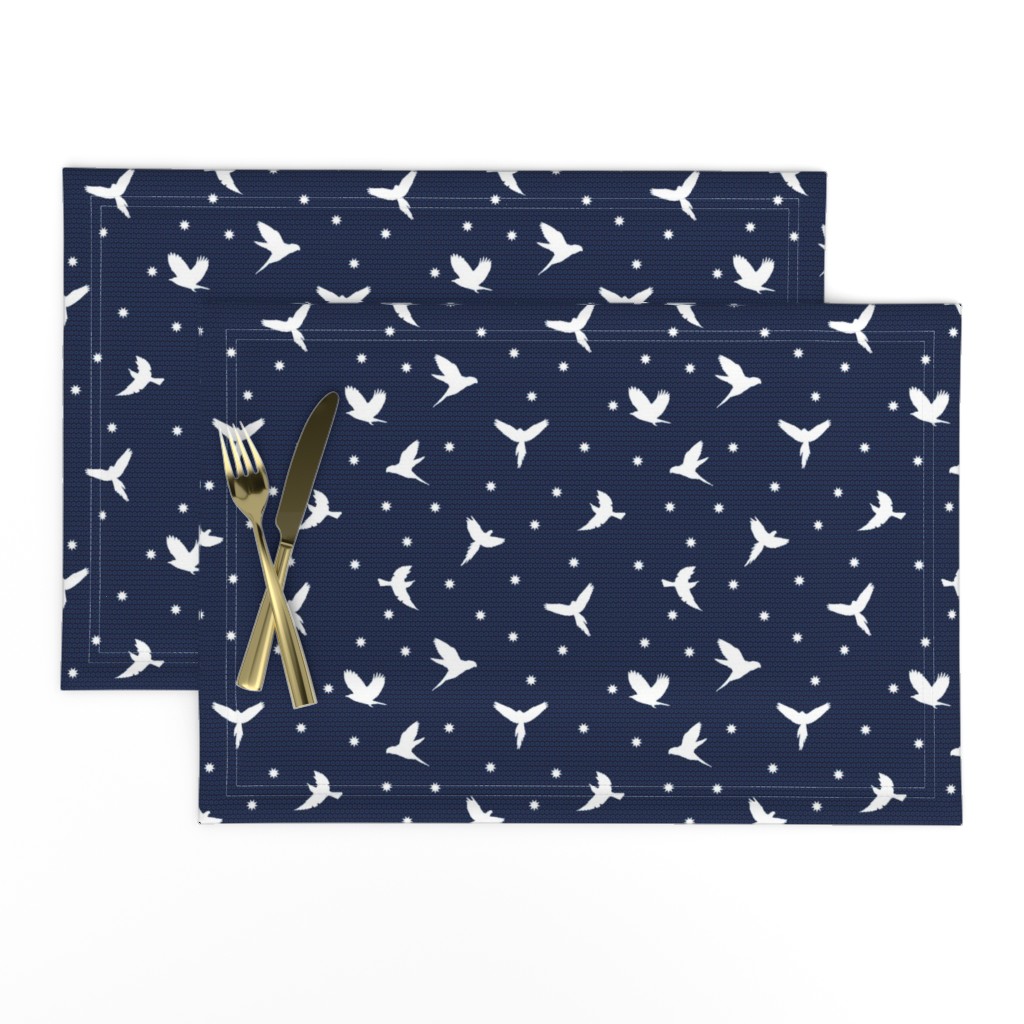 White flying birds on dark blue