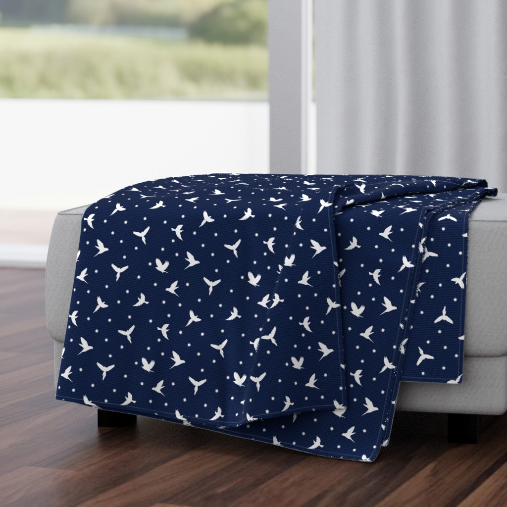 White flying birds on dark blue