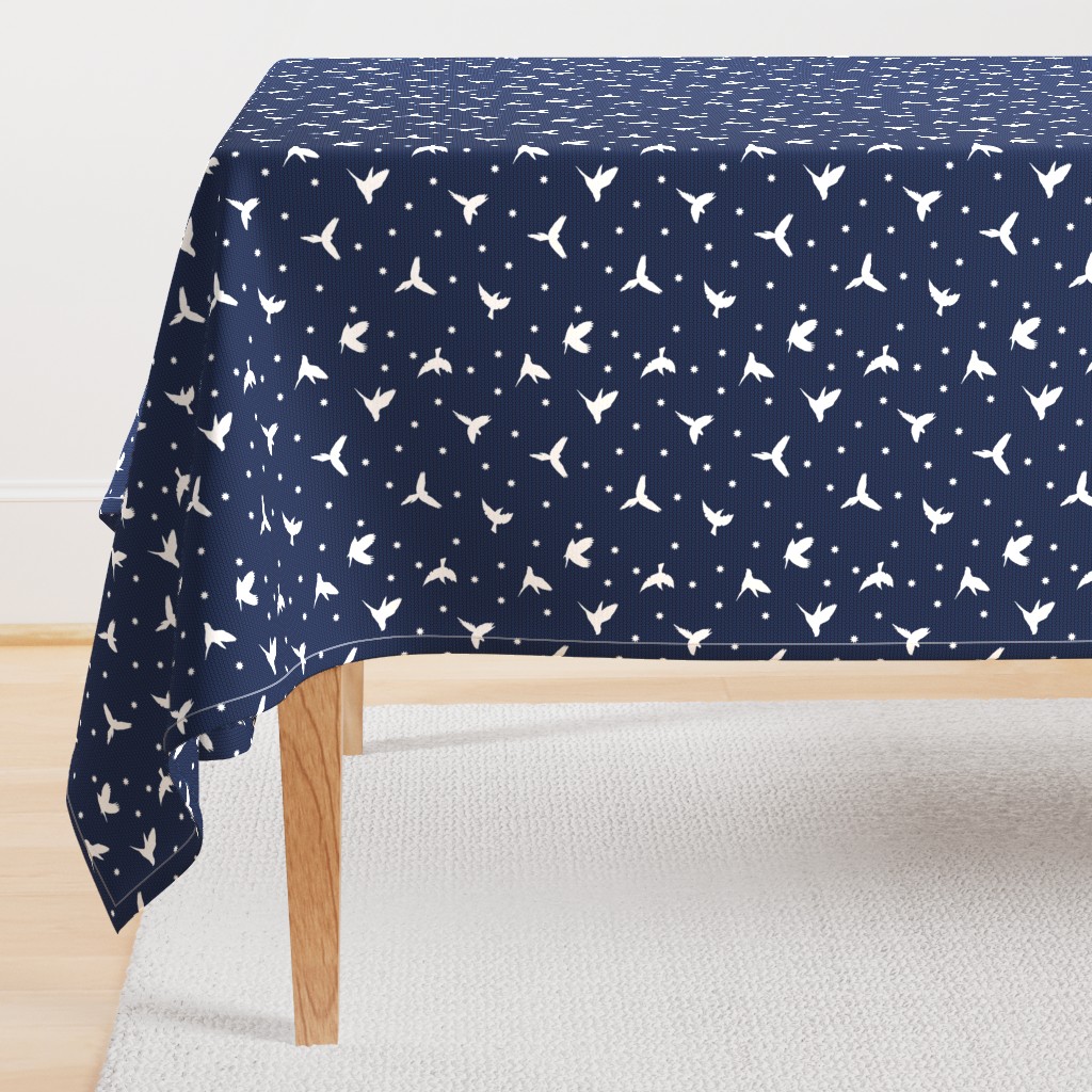 White flying birds on dark blue