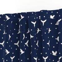 White flying birds on dark blue