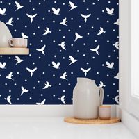 White flying birds on dark blue