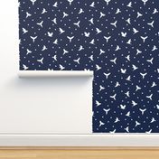 White flying birds on dark blue