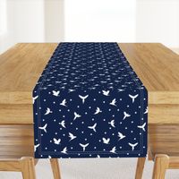 White flying birds on dark blue