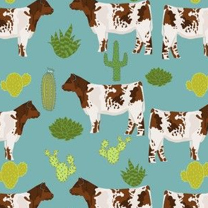 shorthorn cattle fabric cow and cactus design - blue