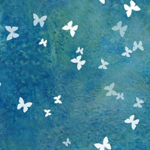 Small white butterflies on blue green