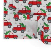 red trucks and christmas trees