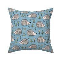 Hedgehog with Leaves and Flowers on Blue