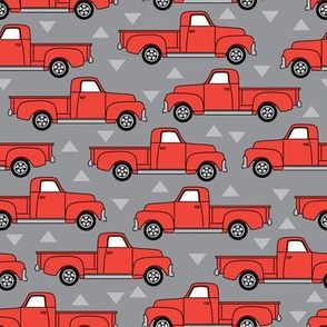 vintage red trucks on grey