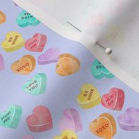 valentines day heart candy - conversation hearts on purple