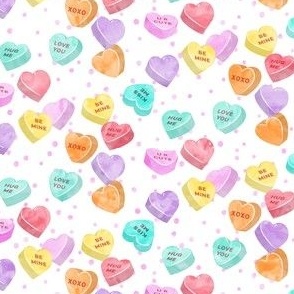 valentines day heart candy - conversation hearts  on  pink spots