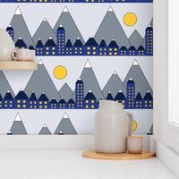 Blue houses in front of snowy mountains and the moon. Geometric shapes winter night. Blue yellow white and gray winter print. Winter village.