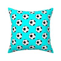 Two Inch Black and White Soccer Balls on Aqua Blue