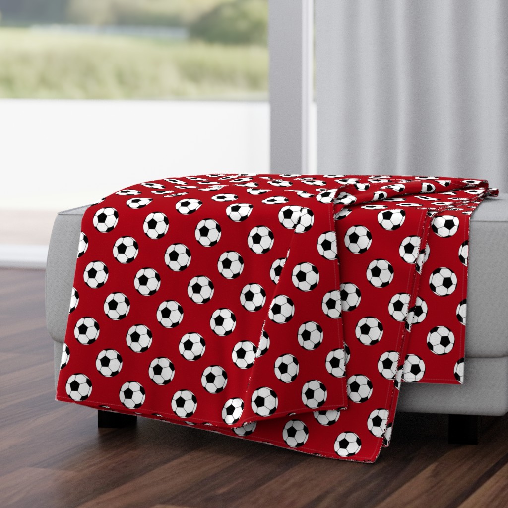 Two Inch Black and White Soccer Balls on Dark Red