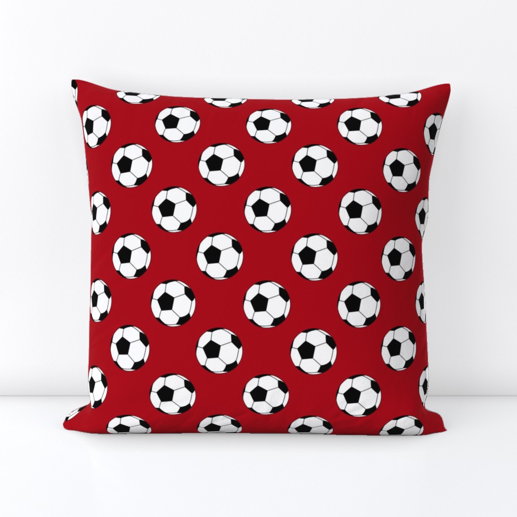 Two Inch Black and White Soccer Balls on Dark Red