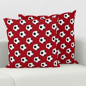 Two Inch Black and White Soccer Balls on Dark Red