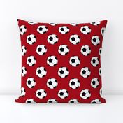 Two Inch Black and White Soccer Balls on Dark Red