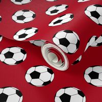 Two Inch Black and White Soccer Balls on Dark Red