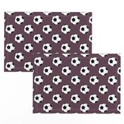 Two Inch Black and White Soccer Balls on Eggplant Purple