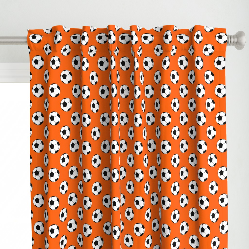 Two Inch Black and White Soccer Balls on Orange