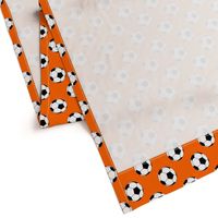 Two Inch Black and White Soccer Balls on Orange