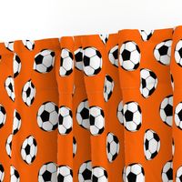 Two Inch Black and White Soccer Balls on Orange