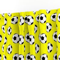 Two Inch Black and White Soccer Balls on Yellow