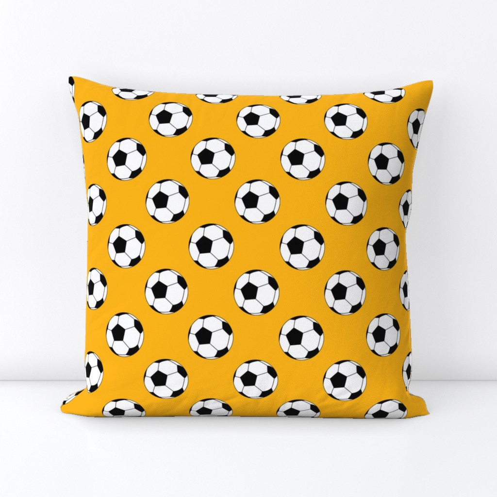 Two Inch Black and White Soccer Balls on Yellow Gold