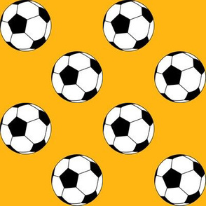 Two Inch Black and White Soccer Balls on Yellow Gold