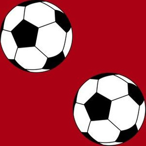 Three Inch Black and White Soccer Balls on Dark Red