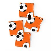 Three Inch Black and White Soccer Balls on Orange