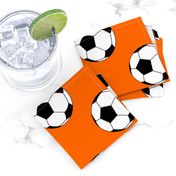 Three Inch Black and White Soccer Balls on Orange