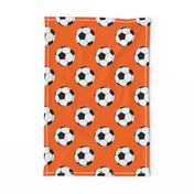 Three Inch Black and White Soccer Balls on Orange