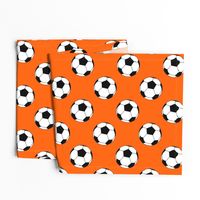 Three Inch Black and White Soccer Balls on Orange