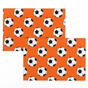 Three Inch Black and White Soccer Balls on Orange