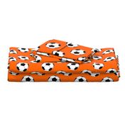 Three Inch Black and White Soccer Balls on Orange