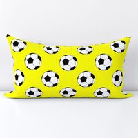 Three Inch Black and White Soccer Balls on Yellow