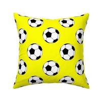 Three Inch Black and White Soccer Balls on Yellow