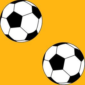 Three Inch Black and White Soccer Balls on Yellow Gold