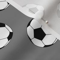Two Inch Black and White Soccer Balls on Medium Gray