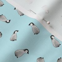 Baby Emperor Penguins on pale blue - half size