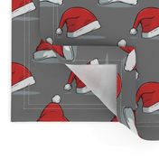 Christmas santa hats on gray