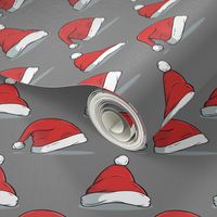 Christmas santa hats on gray