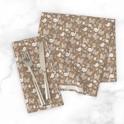 White Foliage Scattered on Brown Paper