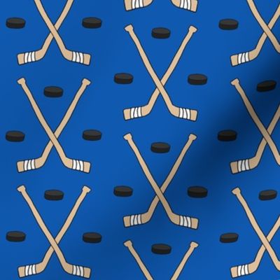 Hockey Sticks and Pucks on Blue - larger