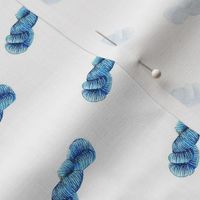 blue yarn skeins on white background