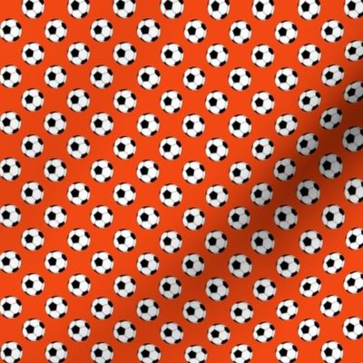 Half Inch Black and White Soccer Balls on Red-Orange