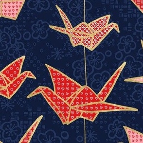 Red origami cranes on navy blue