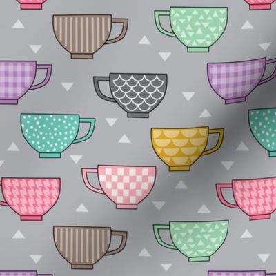 teacups with patterns on grey