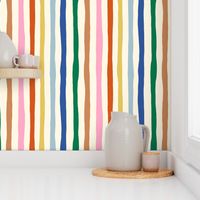 Organic Rainbow Stripe Design: colorful imperfect vertical stripes on cream background.